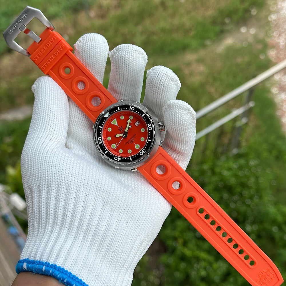 Steeldive SD1975 tuna watch matte orange dial paired with orange rubber strap, outdoor hand shot