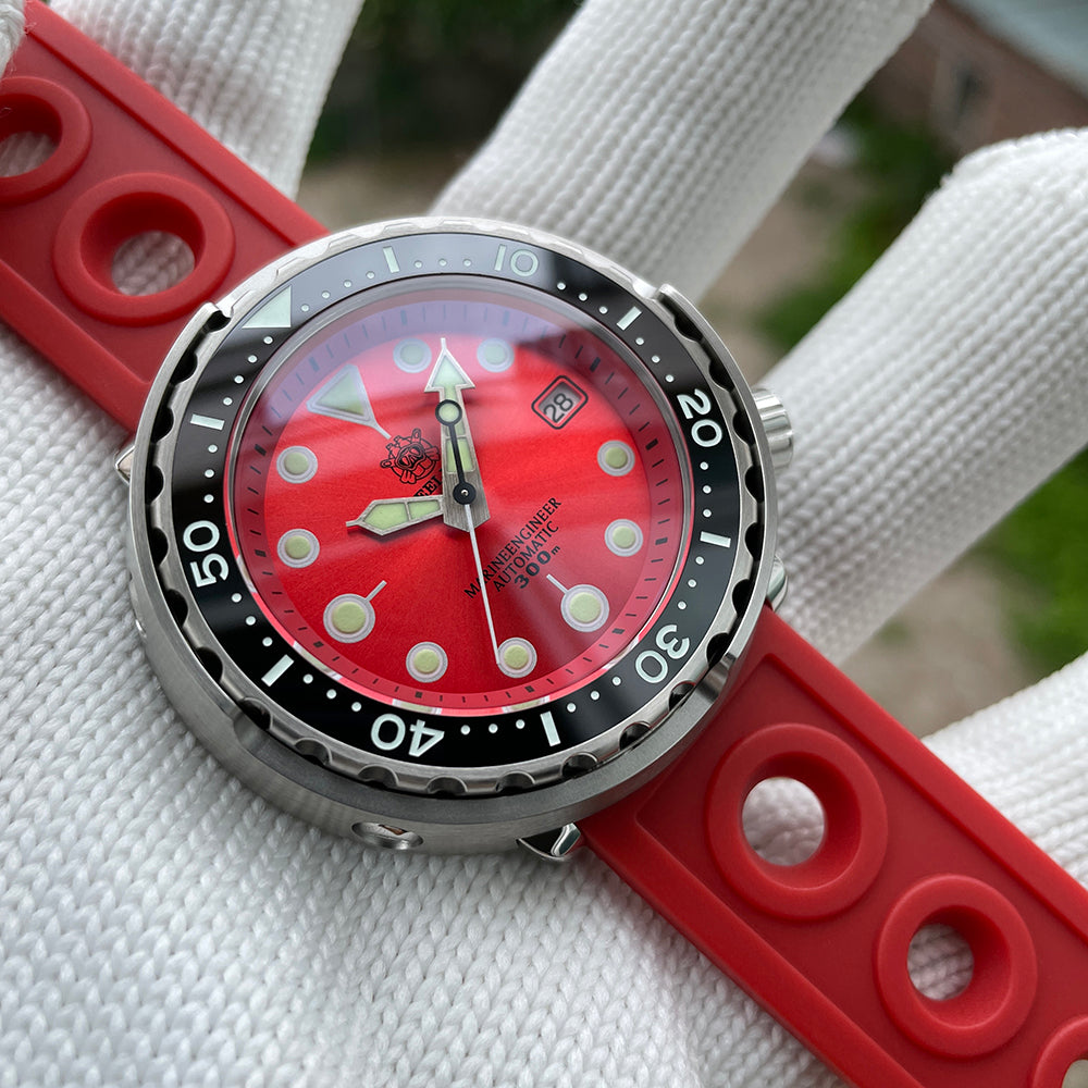 Steeldive SD1975 tuna watch with red sunray dial on red holed rubber strap, angled wrist scene