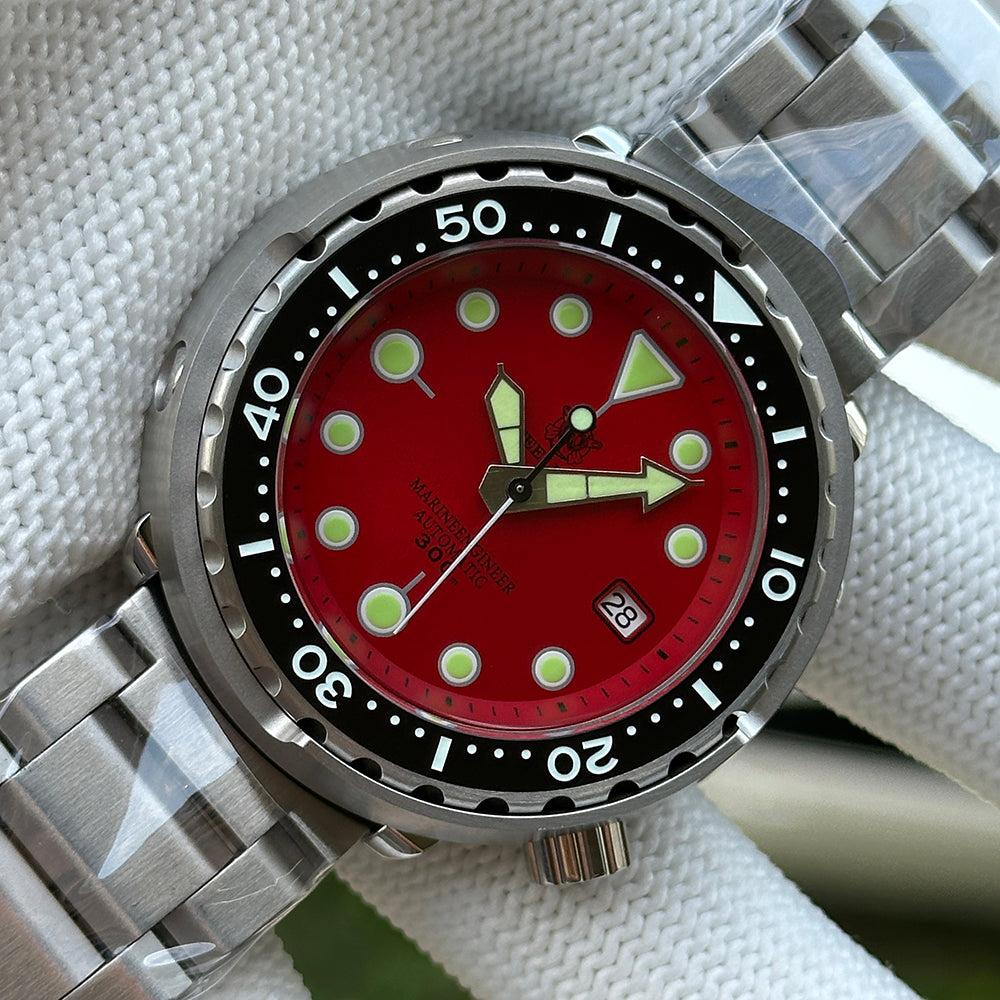 Steeldive SD1975 dial macro showing red sunray finish, applied indices and arrow hour hand