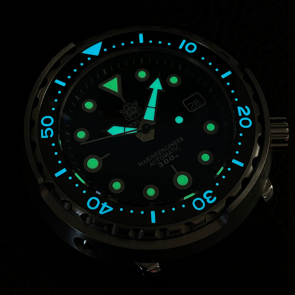 Steeldive SD1975 tuna watch lume shot showing green BGW9 indices and blue bezel pip in the dark