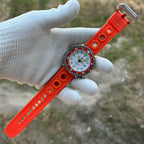 STEELDIVE SD1975N orange bezel on an orange perforated rubber strap held in a gloved hand
