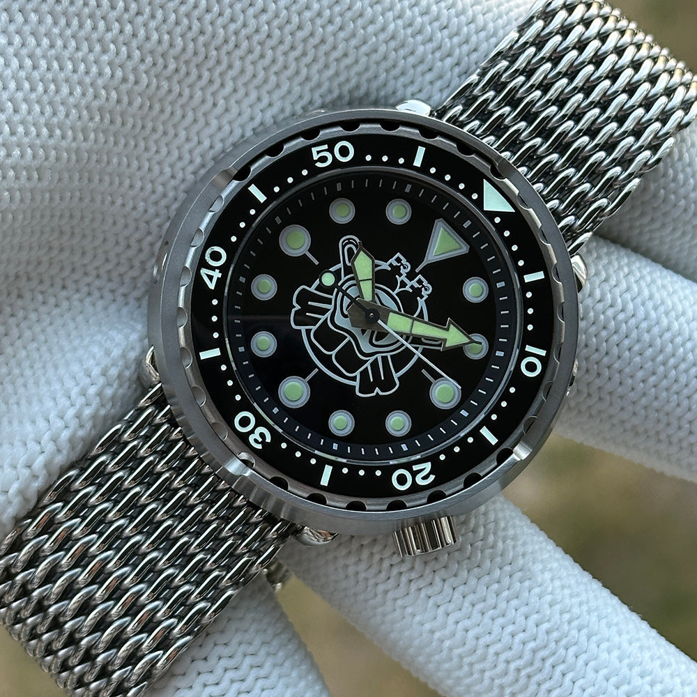 Steeldive SD1975P tuna watch black dial with shark mesh bracelet resting on white wrist cushion