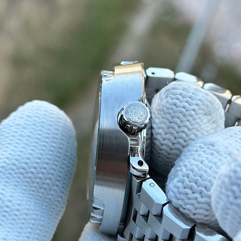 Steeldive SD1975P tuna watch crown and folding clasp detail with engraved logo, held in gloved hand