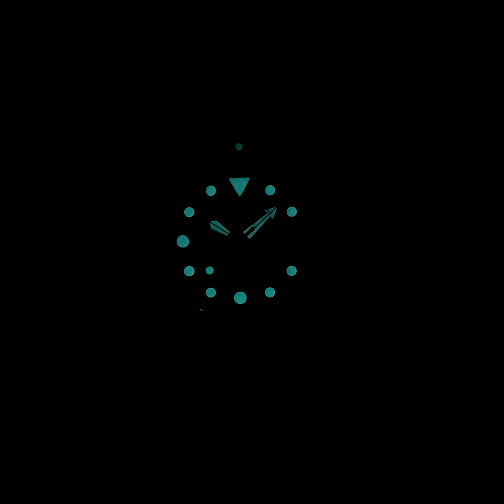 Steeldive SD1975S V1 bronze dive watch lume shot showing blue-green BGW9 glow on dial and hands