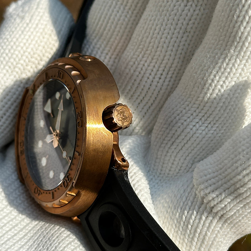 Steeldive SD1975S V1 bronze tuna watch crown detail with engraved logo and brushed bronze case side