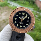Steeldive SD1975S V2 bronze 300m dive watch dial macro showing applied indices and gold arrow hands