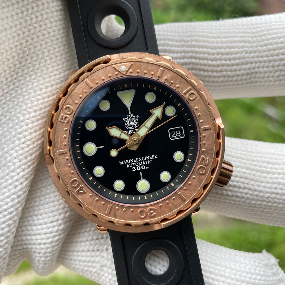 Steeldive SD1975S V2 bronze dive watch on woven backdrop with black rubber strap, lifestyle shot