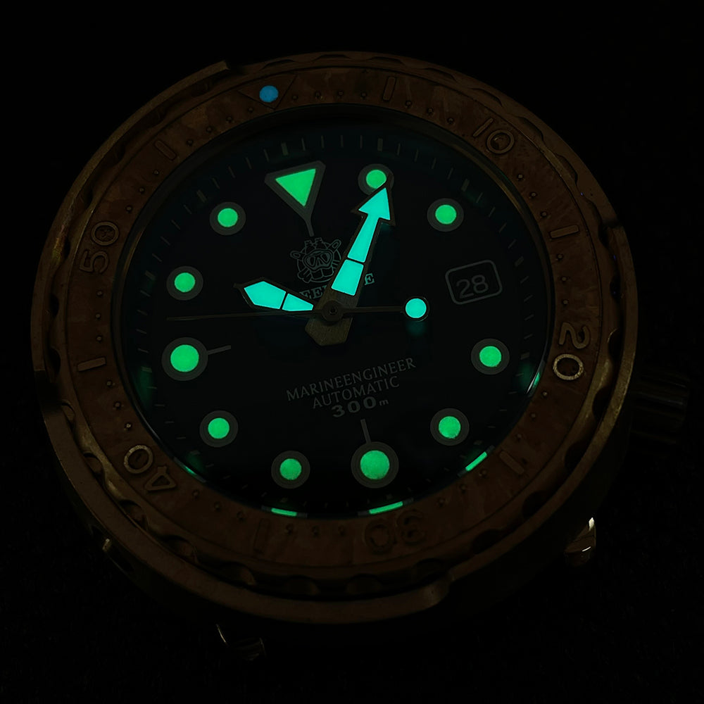 Steeldive SD1975S V2 bronze dive watch glowing with C3 green lume on indices and hands in the dark