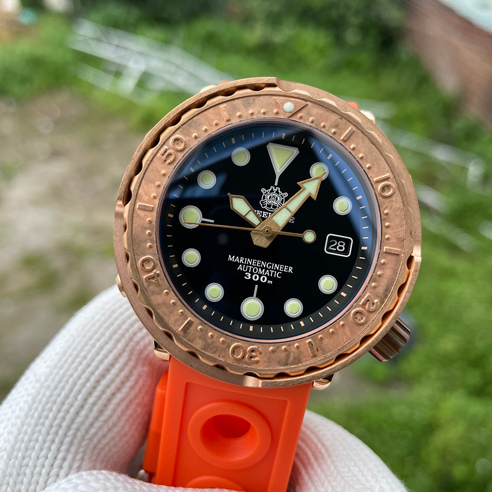 Steeldive SD1975S V2 bronze dive watch front three quarter angle with orange rubber strap outdoors