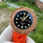 Steeldive SD1975S V2 bronze dive watch front three quarter angle with orange rubber strap outdoors