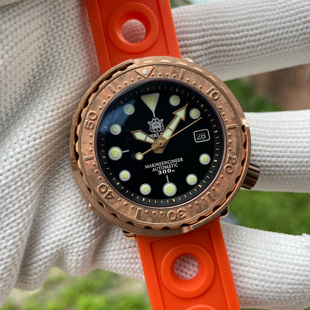 Steeldive SD1975S V2 bronze dive watch on woven backdrop with orange rubber strap, lifestyle shot