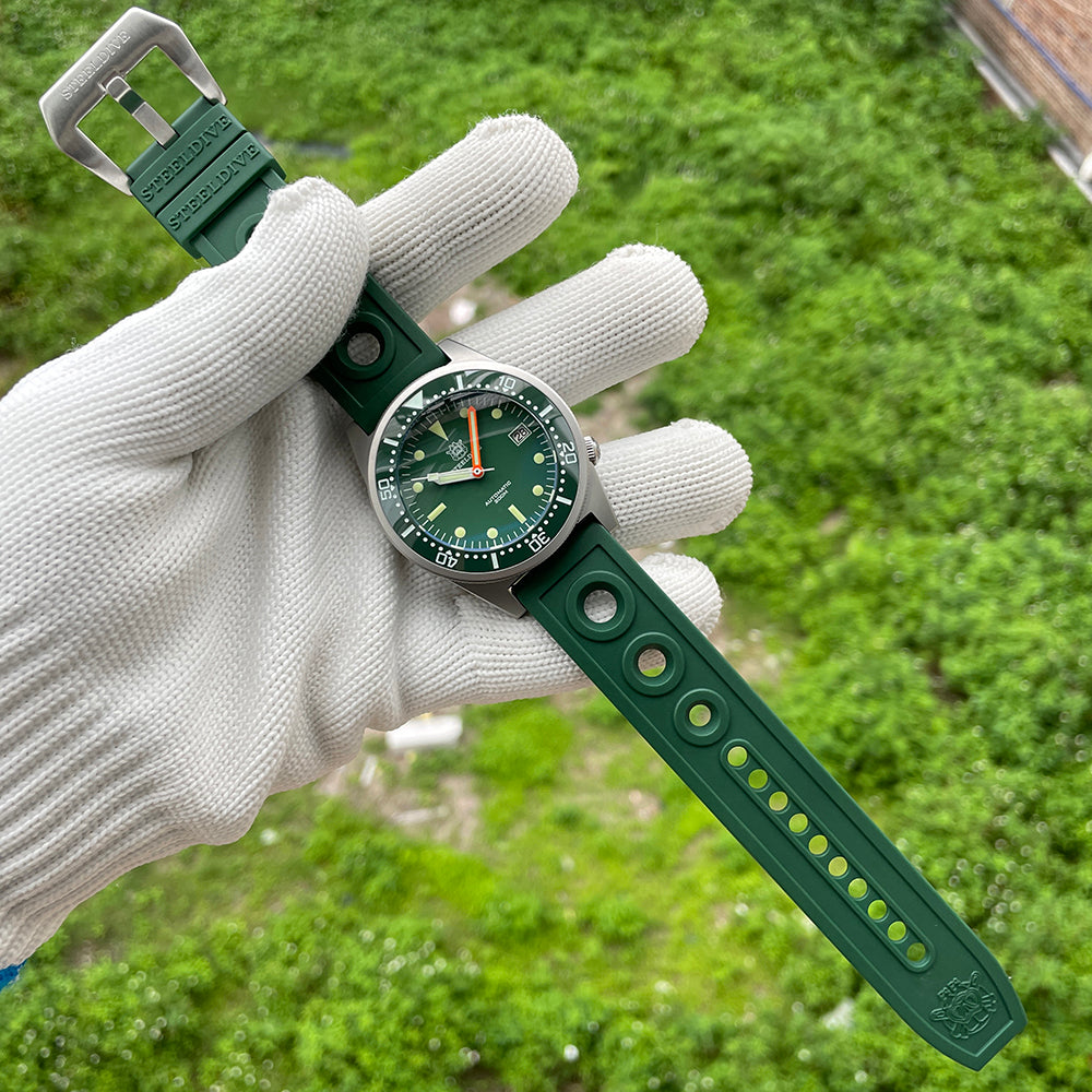 Steeldive SD1979 green dial in gloved hand with matching green perforated rubber strap