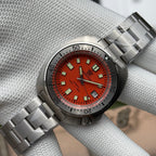 Steeldive SD1981 dive watch with orange dial and steel bracelet, three quarter side view