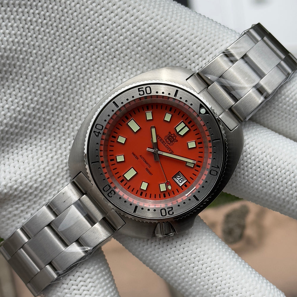 Steeldive SD1981 dive watch with orange dial and steel bracelet, three quarter side view