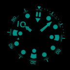 Steeldive SD1982 dial macro showing strong cyan blue lume on indices and hands in the dark