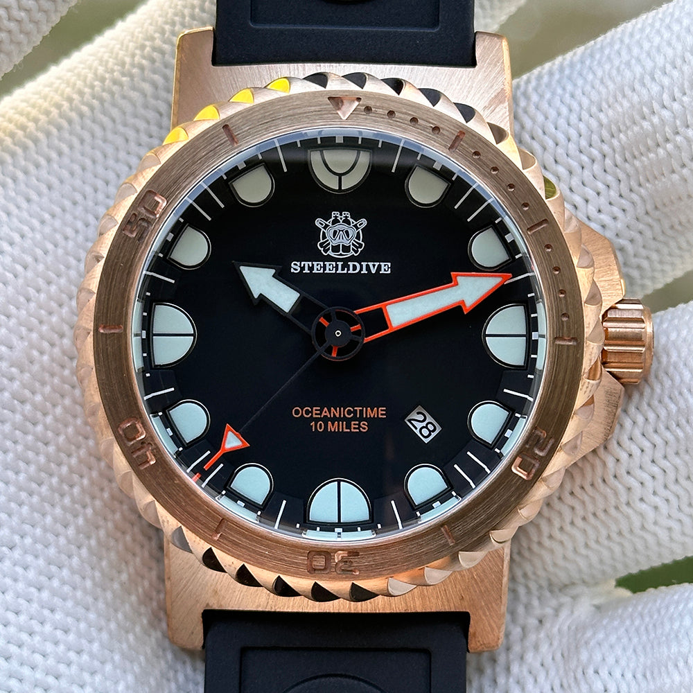 Steeldive SD1982S bronze 46mm watch dial close-up with black dial, lume pip indices and orange accents