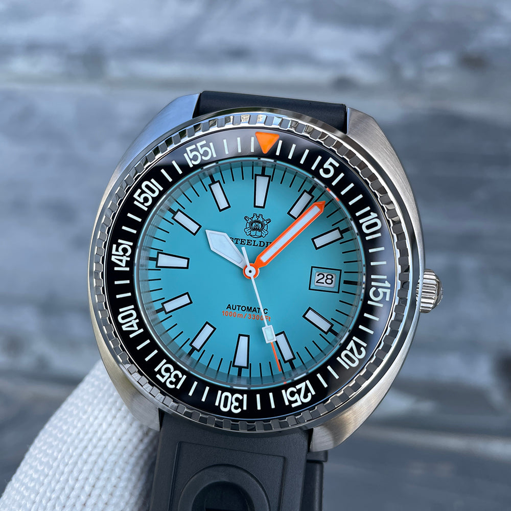 Steeldive SD1983 ceramic dive watch on black rubber strap, three-quarter view showing ice blue dial