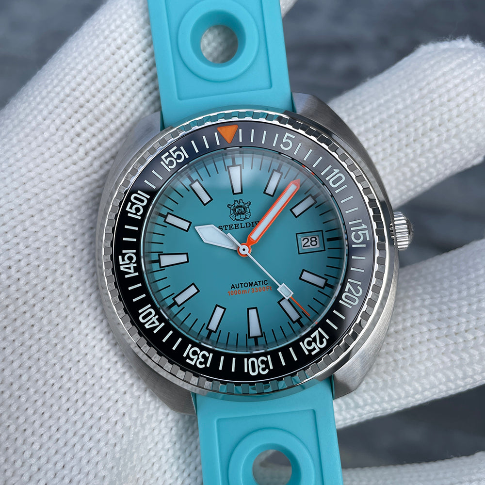 Steeldive SD1983 ceramic dive watch on cyan rubber strap, three-quarter view of ice blue dial and case