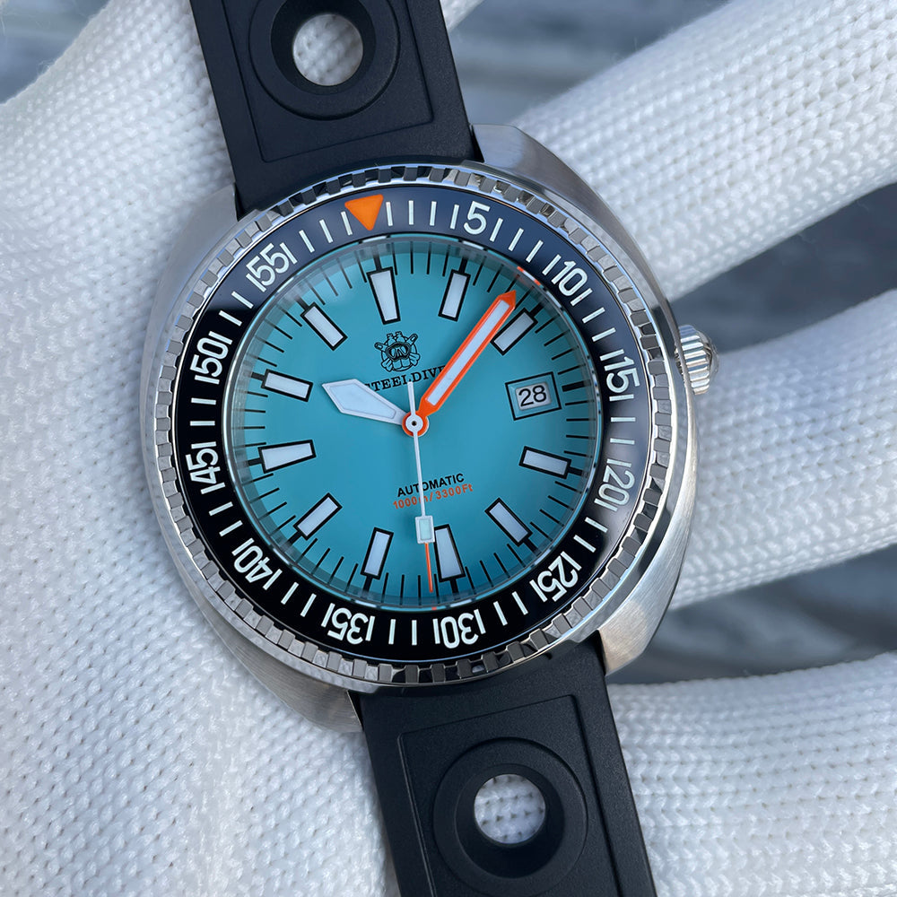 Steeldive SD1983 ice blue dial macro showing applied indices, orange seconds and 1000M Automatic text