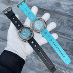 Steeldive SD1983 ceramic dive watches on black and cyan perforated rubber dive straps, held side by side