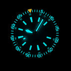 Steeldive SD1983 ceramic dive watch glowing aqua lume on hour markers and bezel pip in the dark