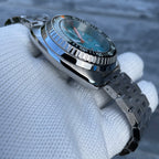 Steeldive SD1983 ceramic bezel side profile showing coin-edge knurling and ice blue dial, gloved hold