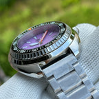 Steeldive SD1983 1000m dive watch purple dial profile on cloth with oyster bracelet, side angle