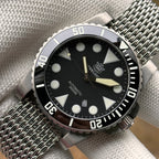 Steeldive SD1987 dive watch black dial close-up with applied indices and mesh bracelet