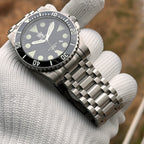 Steeldive SD1987 steel bracelet fitted to black dial diver watch with white lume markers, hero shot