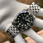 Steeldive SD1987 dive watch jubilee steel bracelet on gloved wrist outdoors, wrist shot