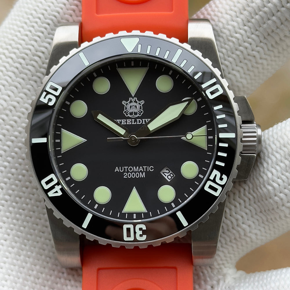Steeldive SD1987 dive watch black dial C3 lume on orange rubber strap, front close-up