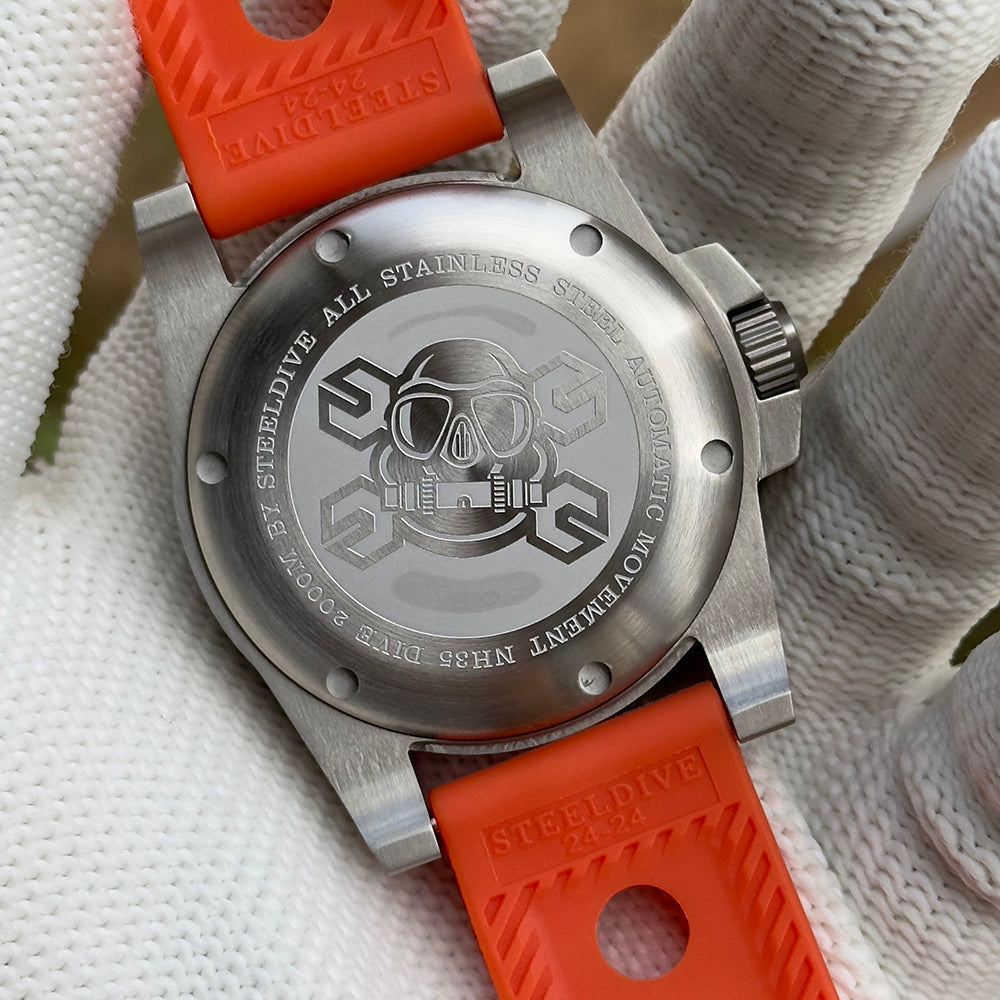 Steeldive SD1987 engraved skull caseback shown with branded orange rubber dive strap
