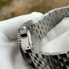 Steeldive SD1987 caseback angle with engraved diver logo, screw-down crown and steel bracelet