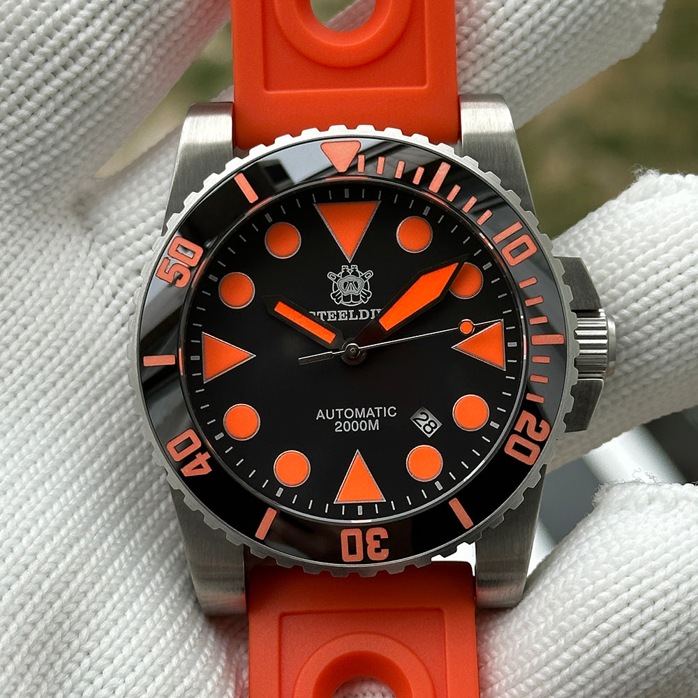 Steeldive SD1987 orange dial diver on orange perforated rubber strap held in gloved hand