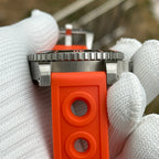Steeldive SD1987 coin-edge bezel and orange perforated rubber strap close-up detail