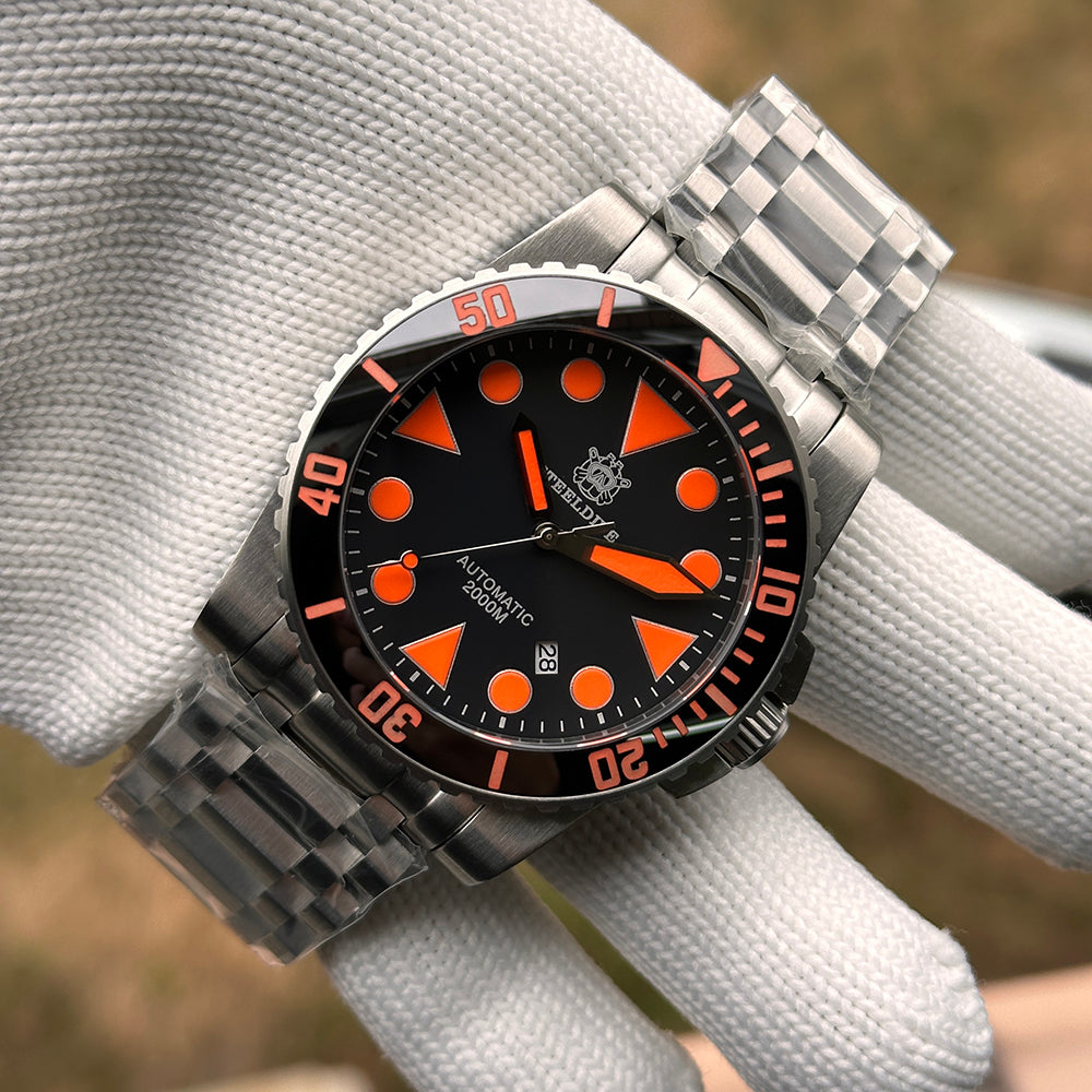 Steeldive SD1987 orange dial variant on tank bracelet held on gloved hand showing full case