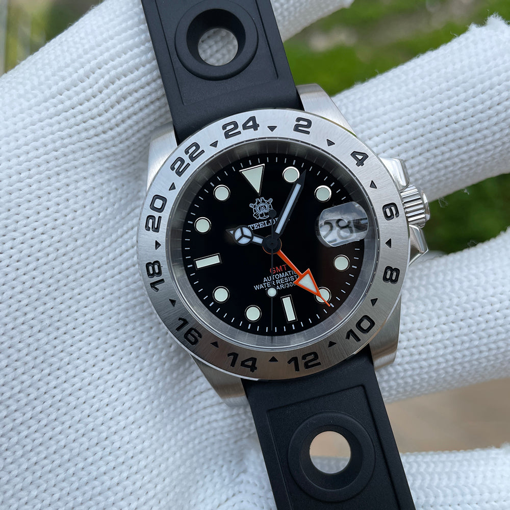 Steeldive SD1992 GMT dive watch with black dial and black rubber strap angled to show 24-hour bezel
