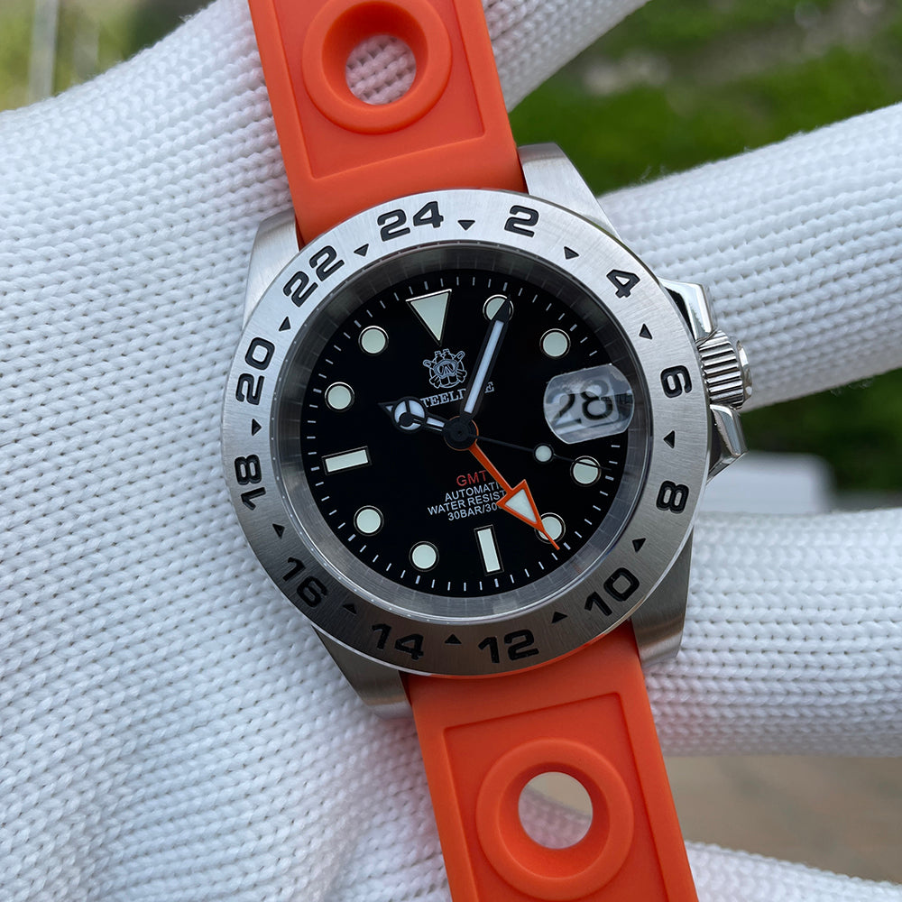 Steeldive SD1992 GMT dive watch with orange rubber strap on cushion, dial and bezel in focus