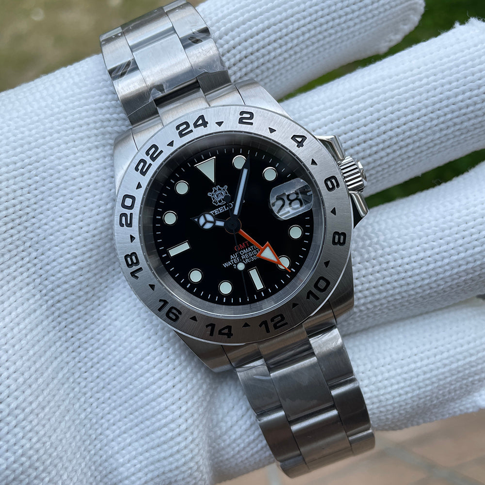 Steeldive SD1992 GMT dive watch on stainless steel oyster bracelet resting on a white cushion