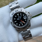 Steeldive SD1992 GMT dive watch on stainless steel oyster bracelet resting on a white cushion