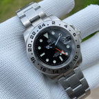 Steeldive SD1992 GMT close-up of black dial, date window and orange GMT hand on oyster bracelet