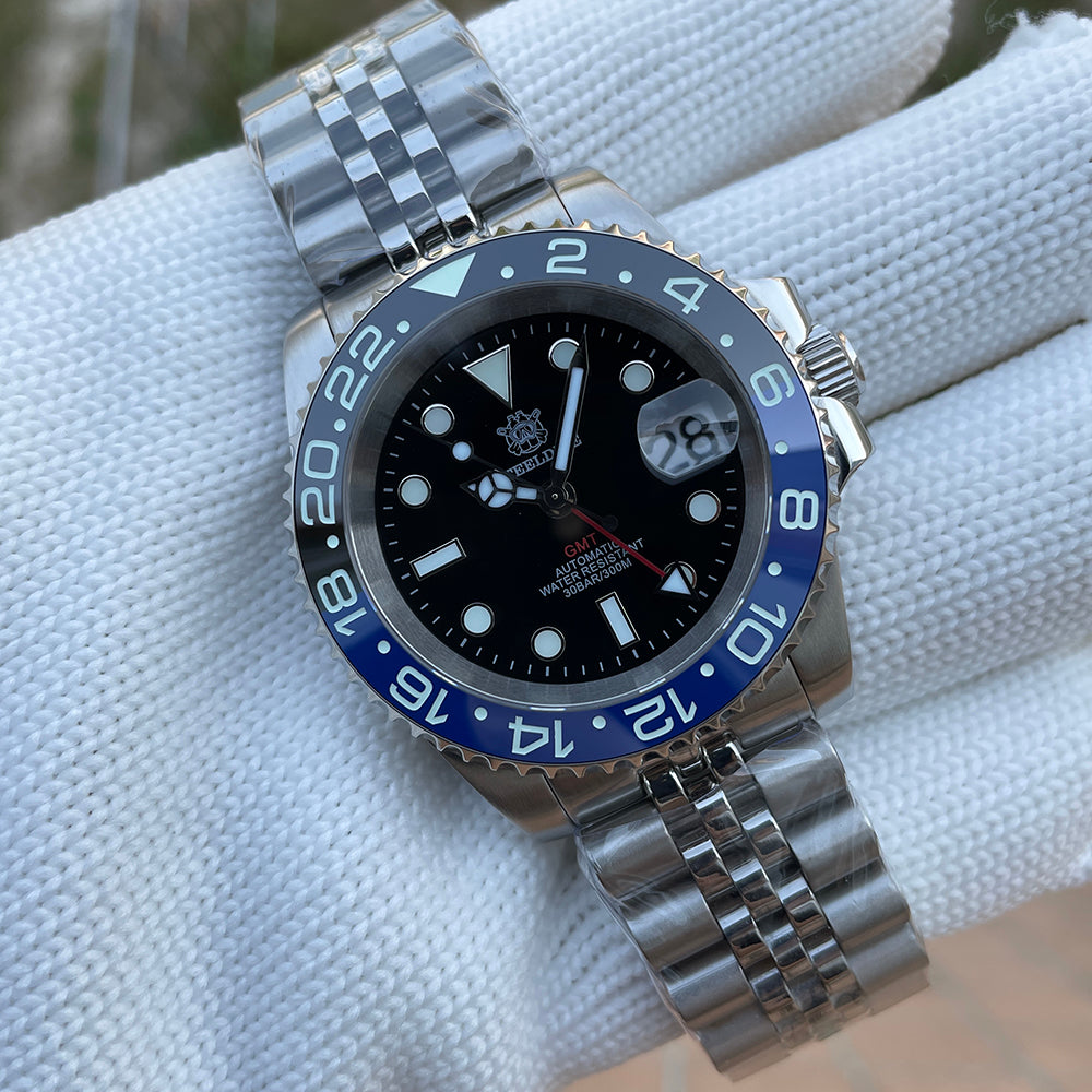 Steeldive SD1993 GMT watch black dial with Batman blue-black bezel and jubilee bracelet, dial macro on pillow