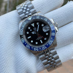 Steeldive SD1993 GMT watch black dial with Batman blue-black bezel and jubilee bracelet, dial macro on pillow