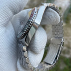 Steeldive SD1993 GMT watch side view showing bi-directional ceramic GMT bezel edge and polished case, gloved hand
