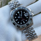 Steeldive SD1993 GMT watch black dial with black ceramic bezel and jubilee bracelet, dial macro on pillow