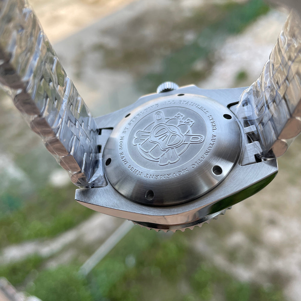 Steeldive SD1993 GMT watch stainless steel screw-down caseback engraved with diver logo and NH34 300m specs