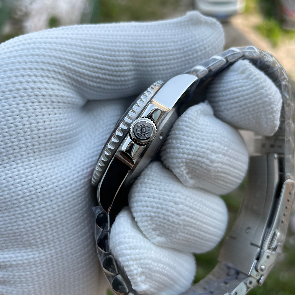 Steeldive SD1993 GMT watch side profile showing signed screw-down crown and polished case flank, gloved hand