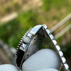 Steeldive SD1993 GMT screw-down crown detail with engraved diver logo and coin-edge bezel