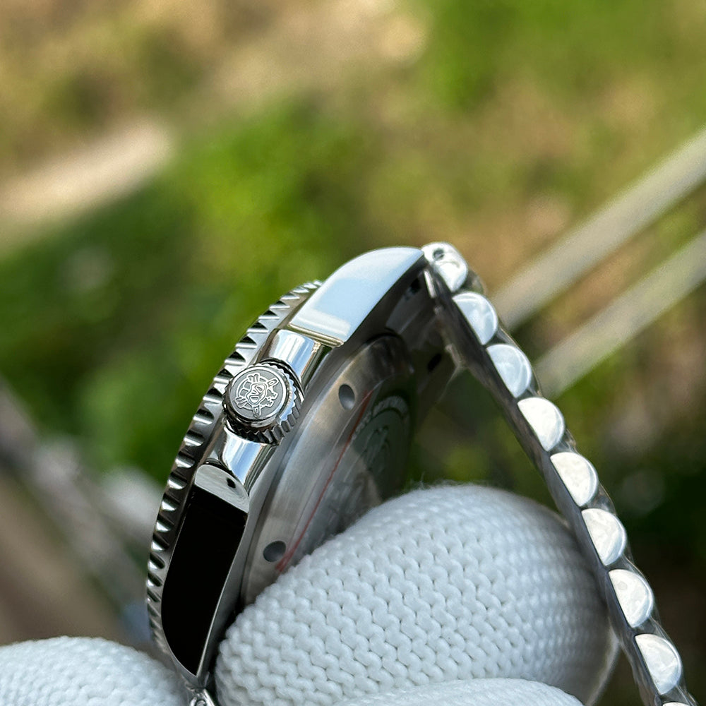 Steeldive SD1993 GMT screw-down crown detail with engraved diver logo and coin-edge bezel