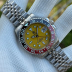 Steeldive SD1993 GMT watch with yellow dial and black-red Coke bezel, steel jubilee bracelet front view